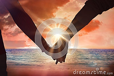 Composite image of couple holding hands rear view Stock Photo