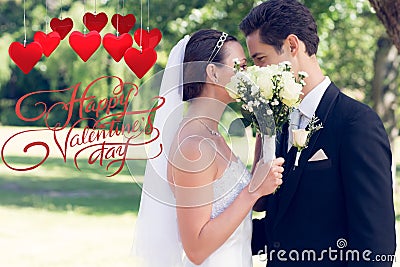 Composite image of couple kissing behind bouquet in garden Stock Photo