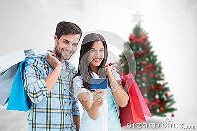 Composite image of couple with shopping bags and credit card Stock Photo