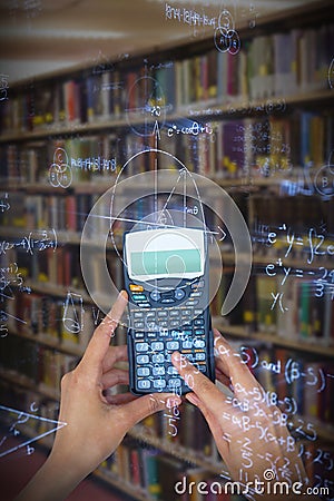 Composite image of cropped hands of businesswoman using calculator Stock Photo