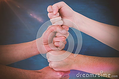 Composite image of cropped image of people with stacked fists Stock Photo