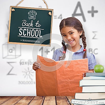 Composite image of cute pupil smiling at camera during class presentation Stock Photo