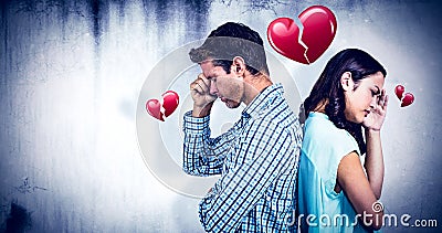 Composite image of depressed couple standing back to back Stock Photo