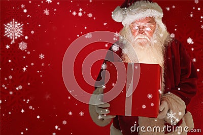 Composite image of father christmas opening a magical christmas gift Stock Photo