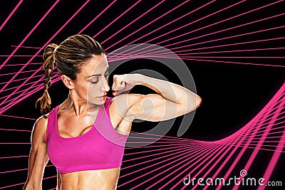 Composite image of female bodybuilder flexing bicep in pink sports bra Stock Photo