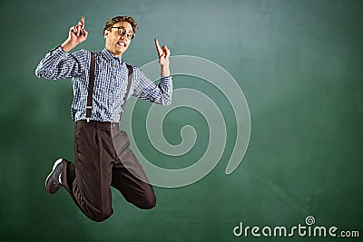 Composite image of geeky hipster jumping and pointing Stock Photo