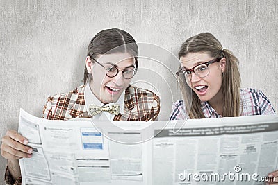 A Composite image of geeky hipsters reading the newspaper Stock Photo