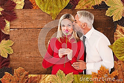 Composite image of handsome man giving his wife a kiss on cheek Stock Photo