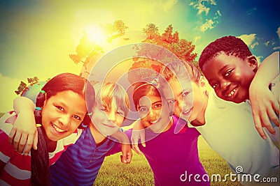 Composite image of happy children forming huddle at park Stock Photo