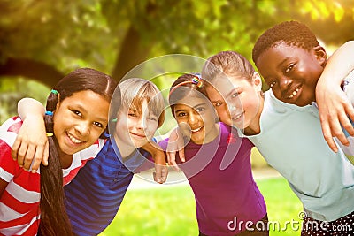 Composite image of happy children forming huddle at park Stock Photo