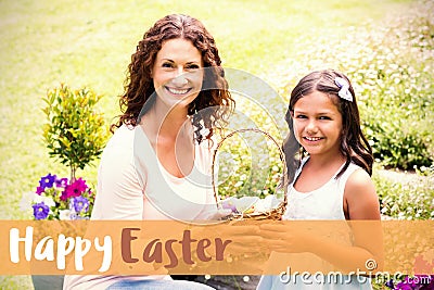 Composite image of happy mother and daughter collecting easter eggs Stock Photo