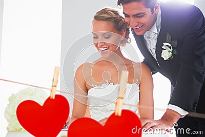 Composite image of happy young couple signing wedding register Stock Photo