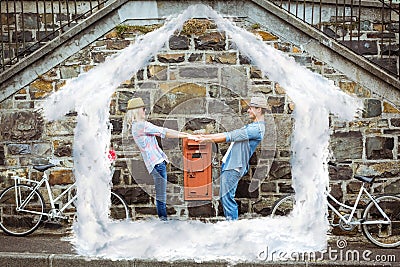 Composite image of hip young couple dancing by brick wall with their bikes Stock Photo