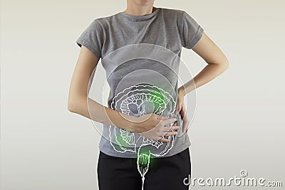 Composite image of infected intestine highlighted green on woman`s body Stock Photo