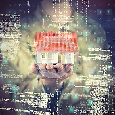 Composite image of mid section of soldier holding model house Stock Photo