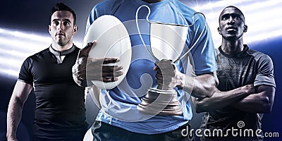 Composite image of mid section of sportsman holding trophy and rugby ball Stock Photo