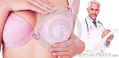 Composite image of mid section of woman in bra examining breast Stock Photo