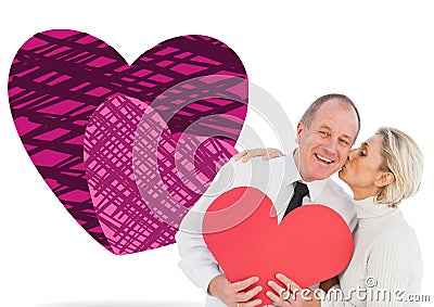 Composite image of older affectionate couple holding red heart shape Stock Photo