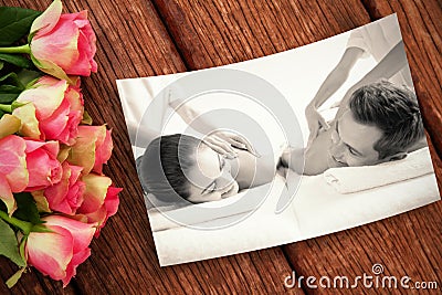 Composite image of peaceful couple enjoying couples massage poolside Stock Photo