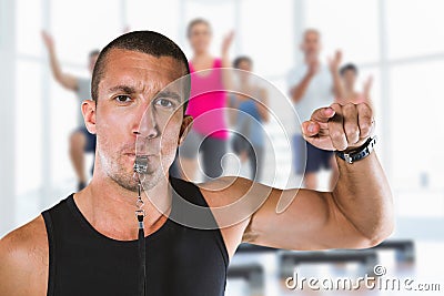 Composite image of portrait of attentive trainer blowing his whistle Stock Photo