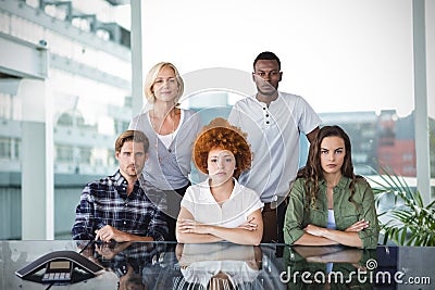 Composite image of portrait of businesspeople at desk Stock Photo