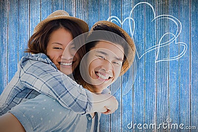 Composite image of portrait of happy man giving piggyback ride to woman Stock Photo