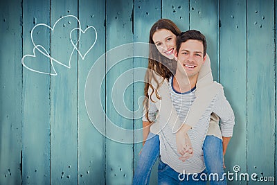 Composite image of portrait of smiling young couple piggybacking Stock Photo