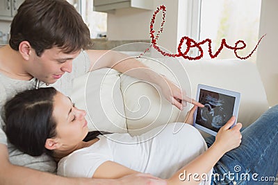 Composite image of prospective parents looking at ultrasound scan on tablet pc Stock Photo