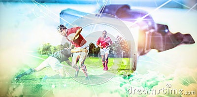 Composite image of rugby players tackling during game Stock Photo