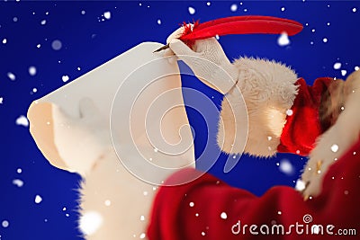 Composite image of santas hand writing list with a quill Stock Photo