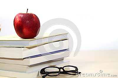 Composite image of school supplies on desk, Apple, books and glasses on the desktop Stock Photo