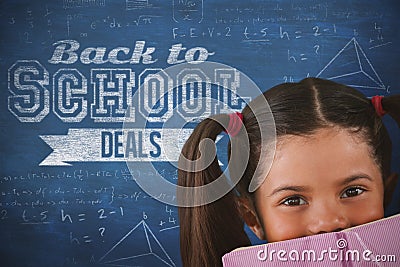 Composite image of schoolgirl covering mouth with book Stock Photo