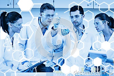 Composite image of scientists working on an experiment at the laboratory Stock Photo