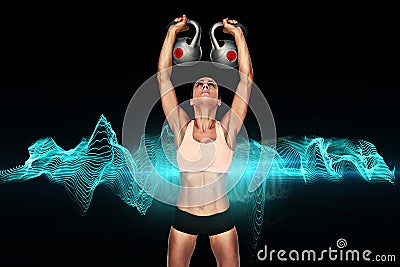 Composite image of serious female crossfitter lifting kettlebells above head Stock Photo