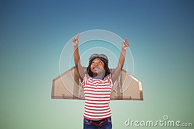 Composite image of smiling boy pretending to be pilot Stock Photo