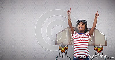 Composite image of smiling boy pretending to be pilot Stock Photo