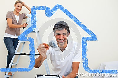 Composite image of smiling couple painting a wall Stock Photo