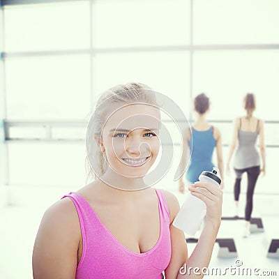 Composite image of smiling healthy woman with water bottle Stock Photo