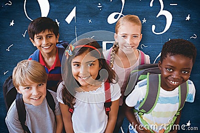 Composite image of smiling little school kids in school corridor Stock Photo