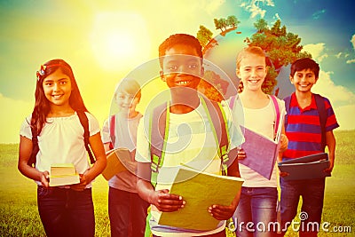 Composite image of smiling little school kids in school corridor Stock Photo