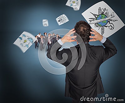 Composite image of stressed businessman with hands on head with tiny businessmen Stock Photo