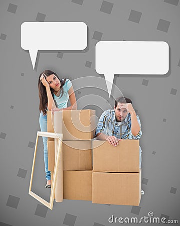 Composite image of stressed young couple with moving boxes Stock Photo