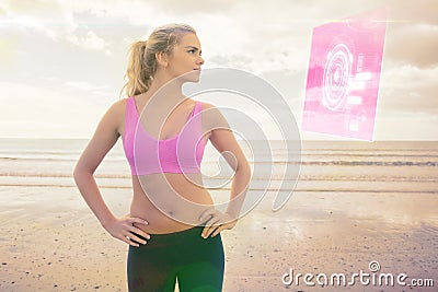 Composite image of toned woman with hands on hips on beach Stock Photo