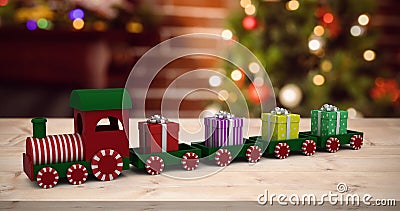 Composite image of train model carrying gift boxes Stock Photo