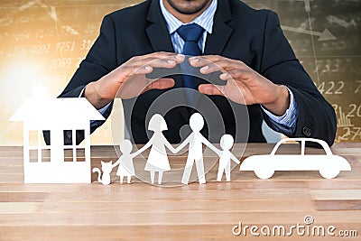 Composite image of underwriter protecting family in paper with his hands Stock Photo