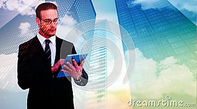 Composite image of unsmiling businessman using tablet pc Stock Photo