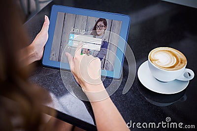 Composite image of woman having coffee and using her tablet Stock Photo