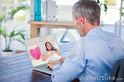 Composite image of woman lying in her bed next to a pink heart pillow Stock Photo