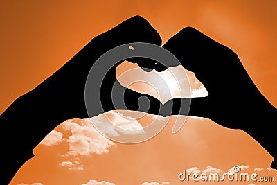 Composite image of woman making heart shape with hands Stock Photo