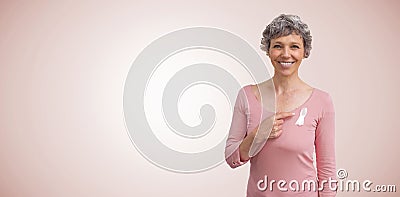 Composite image of woman in pink outfits showing ribbon for breast cancer awareness Stock Photo